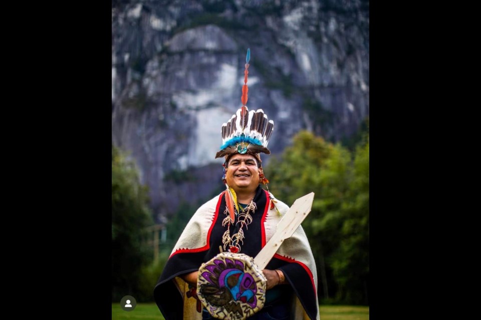 Gyauustees (also known as Whea and Micheal Frase)r, in front of the Stawamus Chief. 