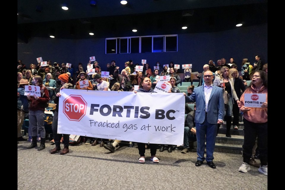 After the meeting ended, many people in the crowd held up signs that said, “Stop FortisBC.”