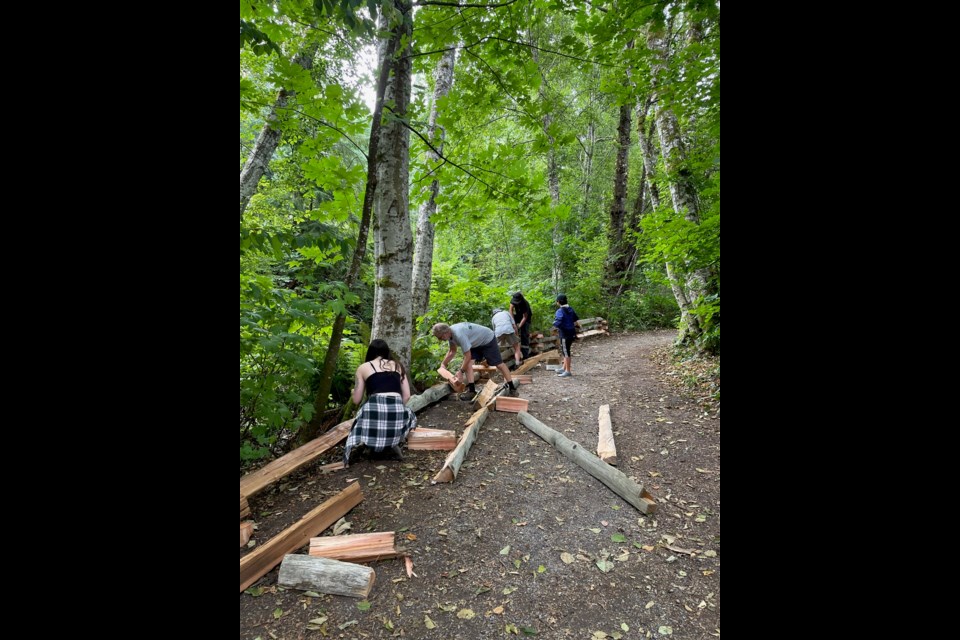 Volunteers put up the fence at Coho Park on Monday, Aug. 16. 