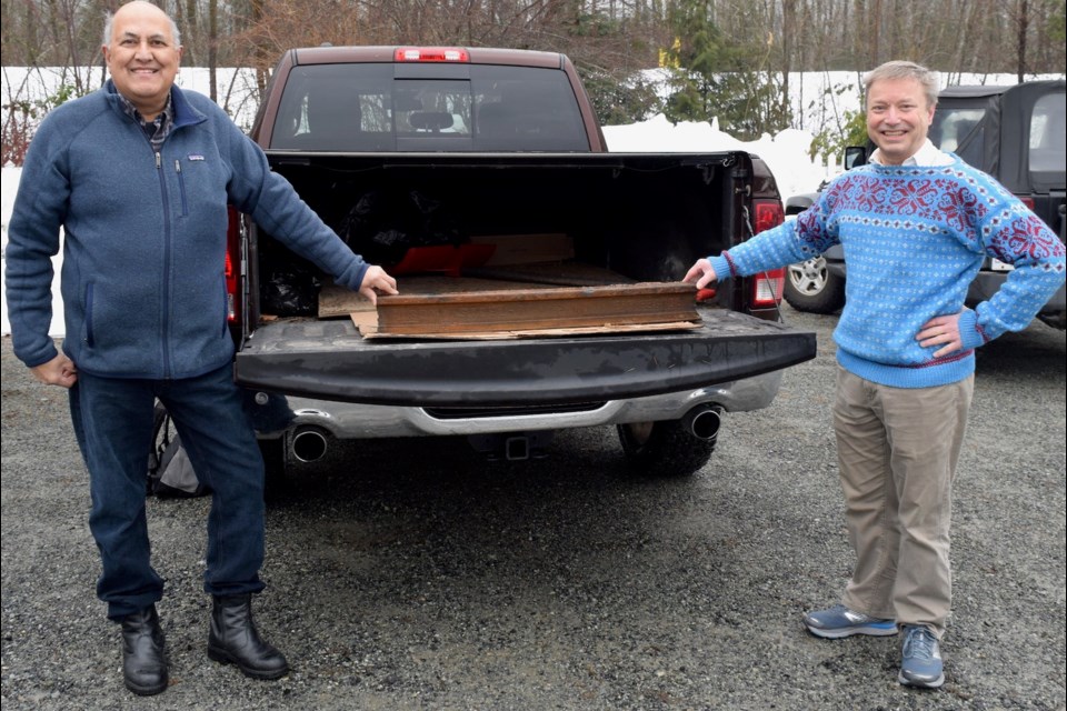 Jaswant Singh Biln, of the Railway Museum of British Columbia and Eric Andersen, of the  Sea to Sky Forestry Centre Society with a piece of the recently discovered rail. 