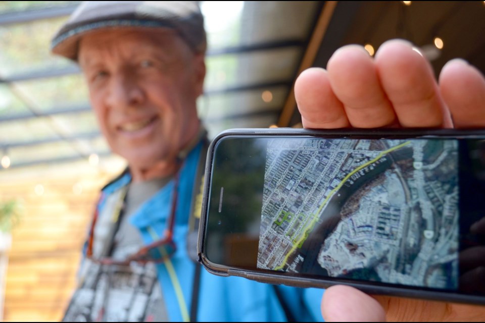 Cliff Jennings with a map of the trail in question on his phone. 