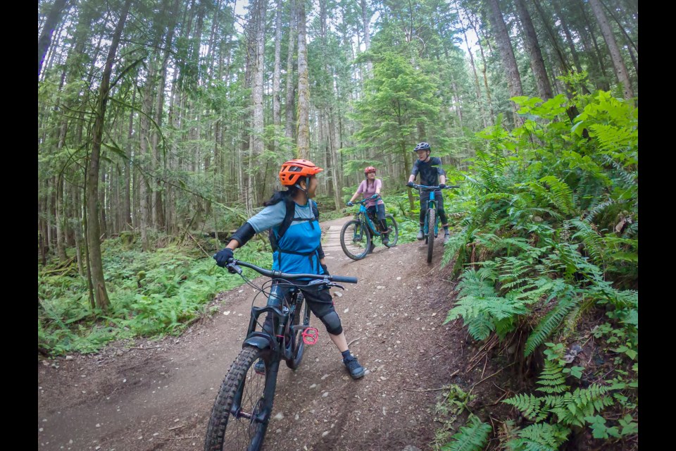 A family biking on Squamish trails. 
