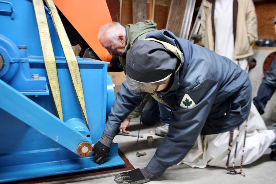 Ron Wilson and Sister Mary Magdalen installing the turbine.