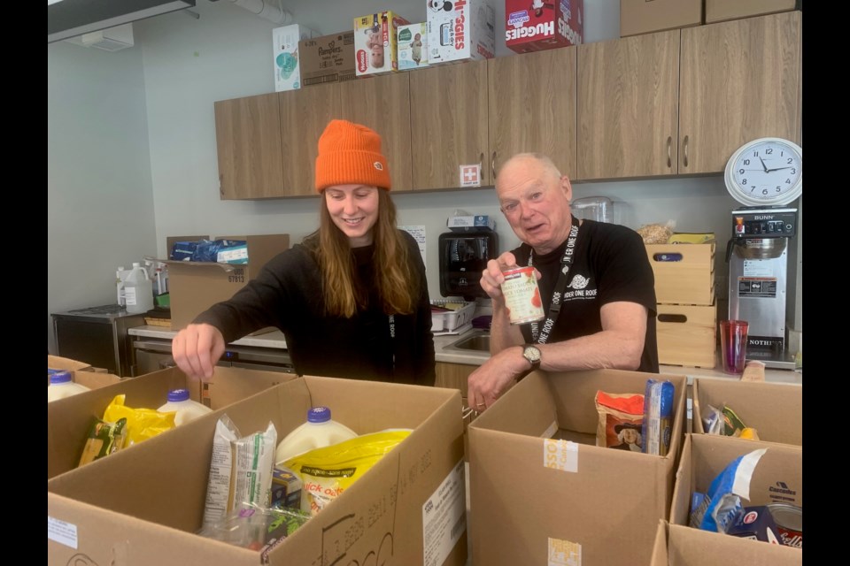 Abigail Watson, the food bank's client co-ordinator and volunteer Peter Hart with food hampers. 