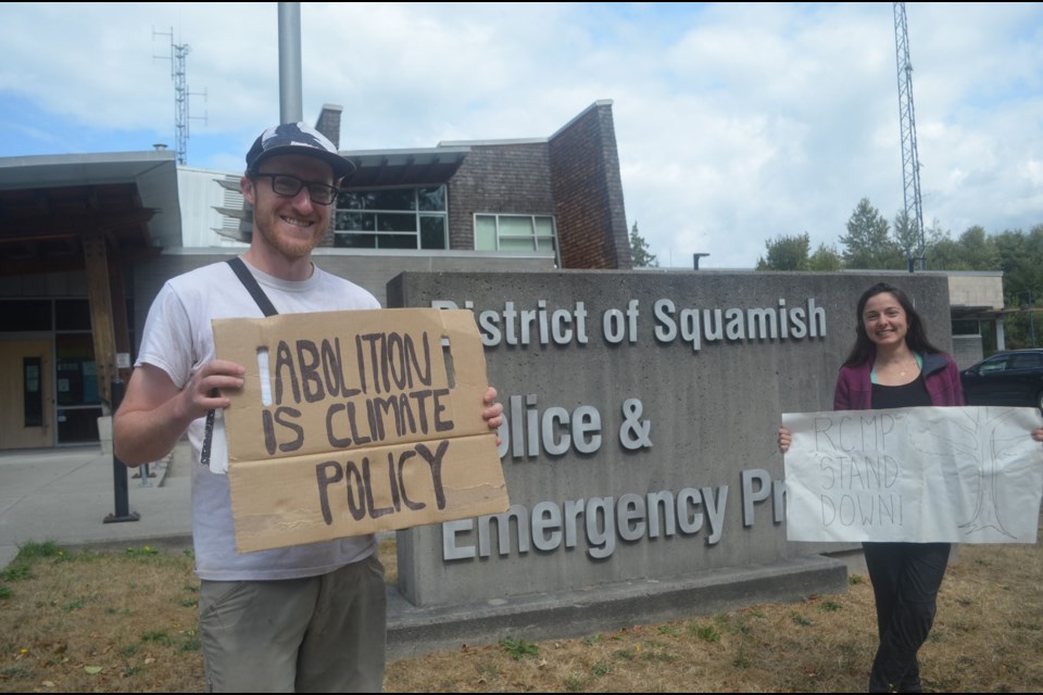 A couple of those demonstrating outside the RCMP detachment in Squamish on Monday.
