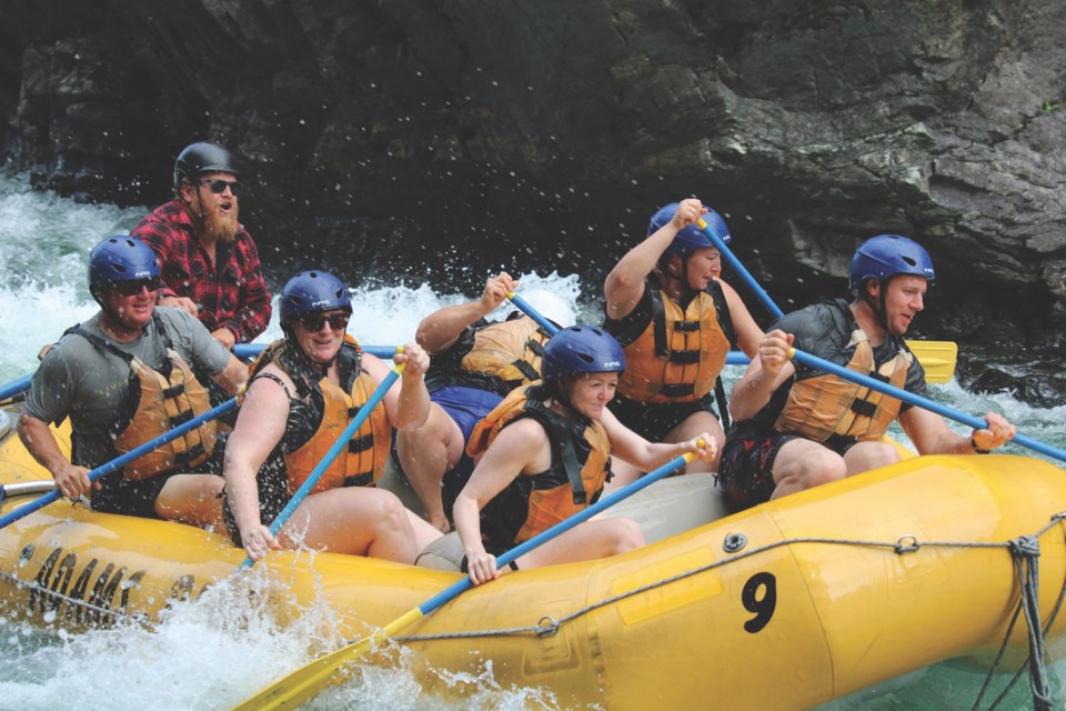 Will Johnson (in red) takes clients whitewater rafting down the Adams River. 