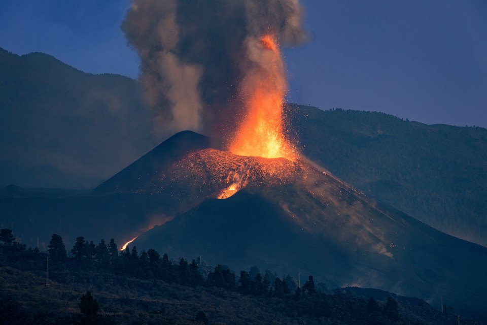 Volcanic eruption at sunset. View of the Cumbre Vieja Volcano with a column of smoke and lava coming out of the main cone. A new survey wants to know what Sea to Sky folks know about volcanoes. 