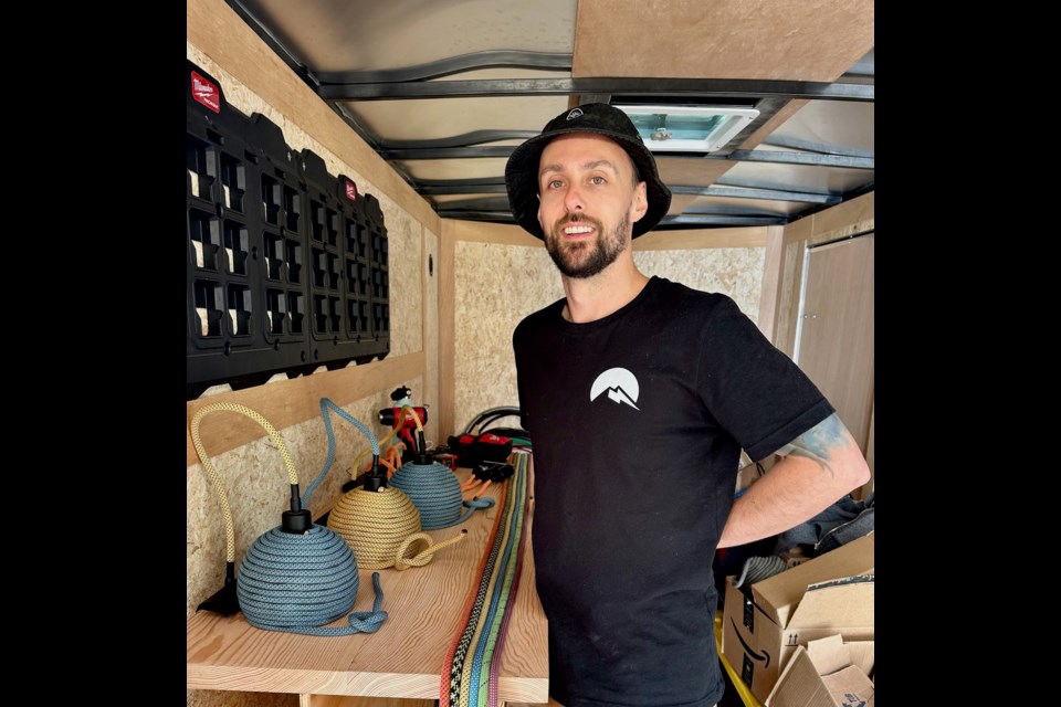 Matt Cress with a few of his hand-crafted light fixtures.