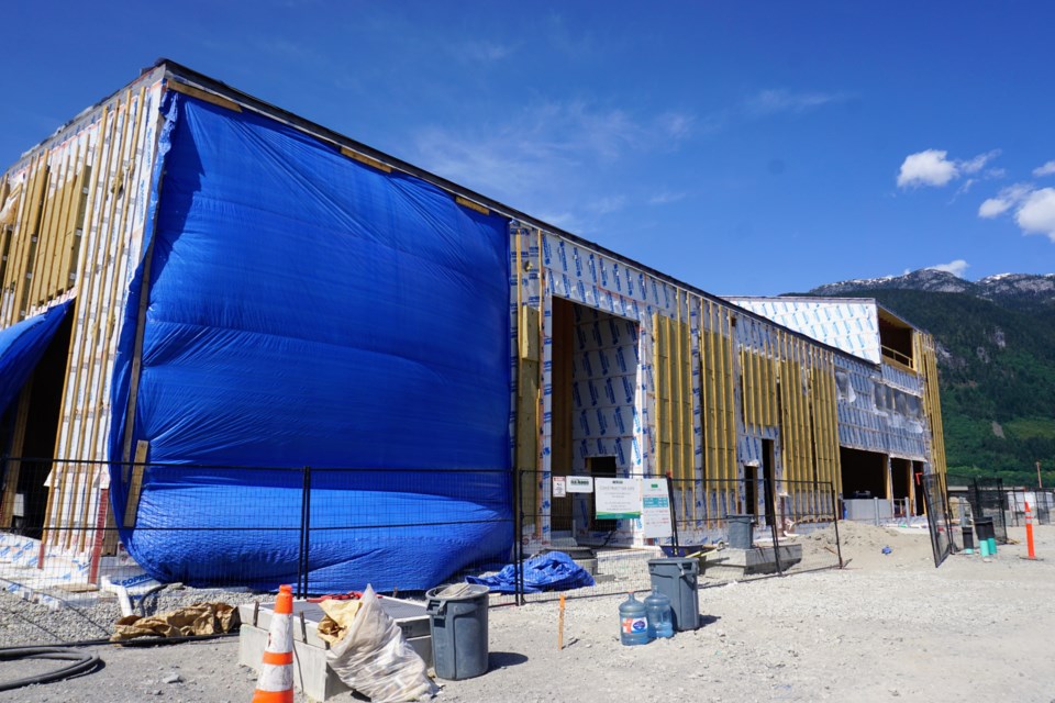 The blue tarp covers where the brewery will be. The far side is the Presentation Centre and Public House.                           
