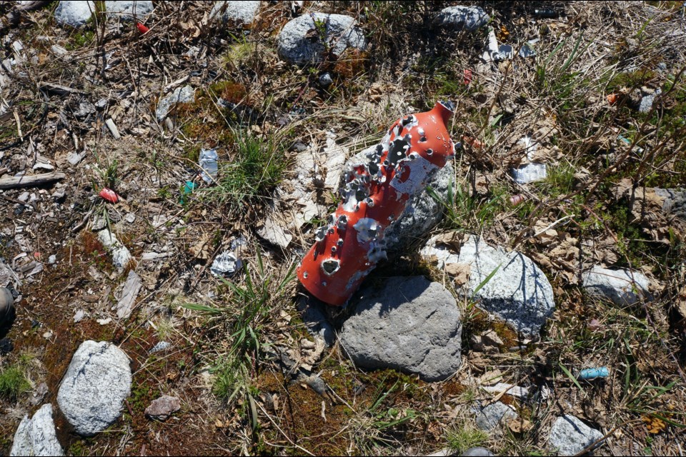 A fire extinguisher shot full of holes at the very spot where a wildfire started last May.                                