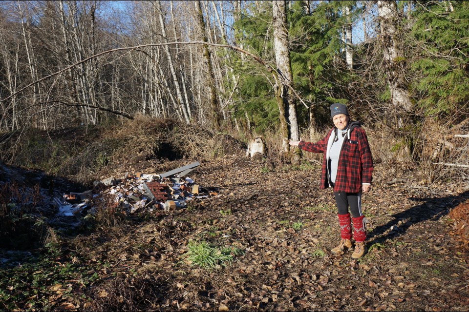 Shirley Lewis points out some of the trash left on Nation land.                            
