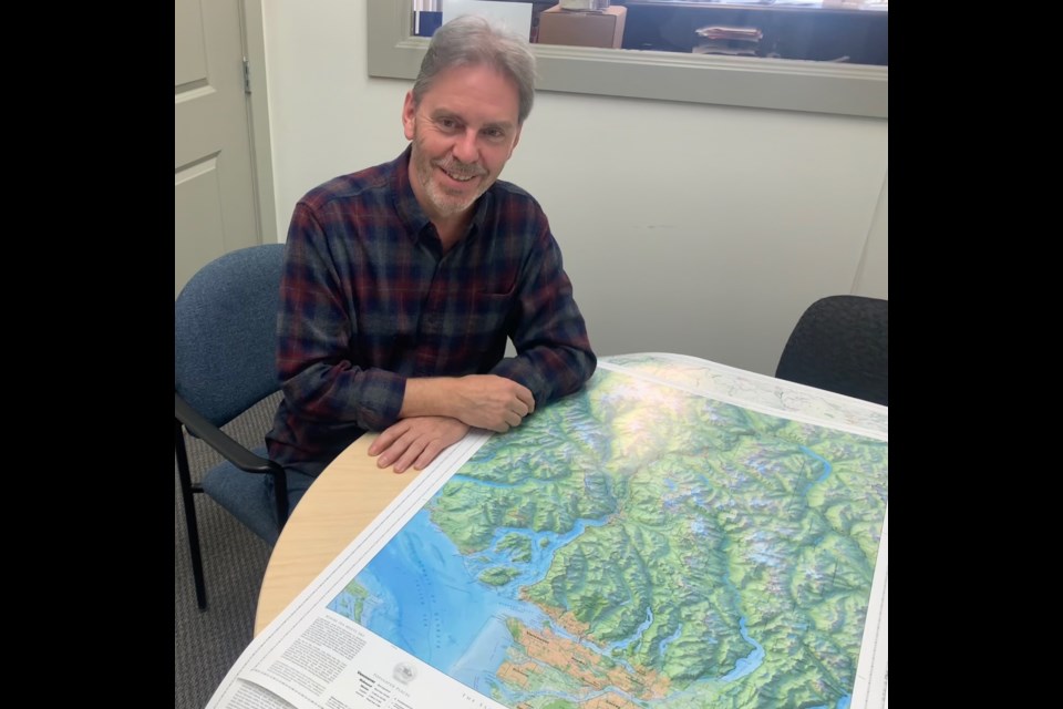  Jeff Clark, of Clark Geomatics with two of his maps at The Squamish Chief's office on Thursday.
