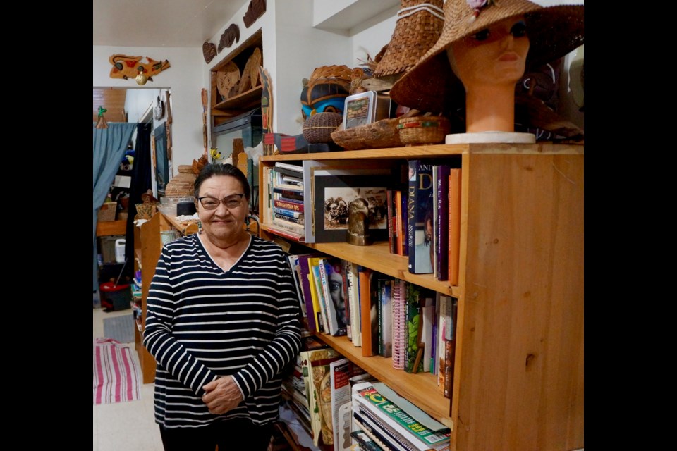 Donna Billy in her Squamish home. Many of the items on the book shelves beside her were given to her as gifts, she said.                    