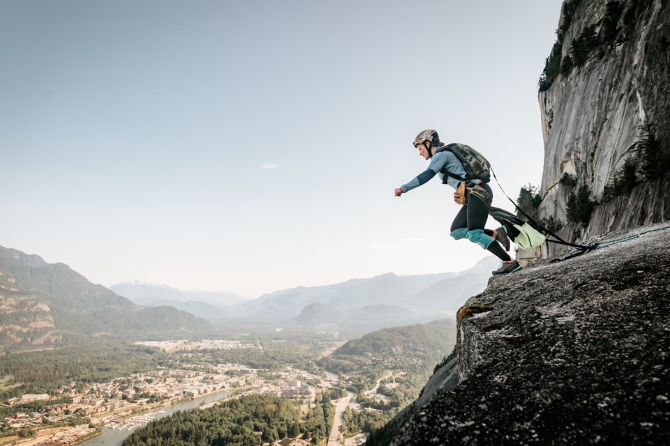 Photographer Tyler Stallings captures the moment Squamish BASE jumper Alenka Mali steps off of the First Peak of the Stawamus Chief at sunrise. 
