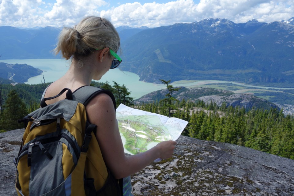 squamishwomanlooksat-trailmapgettyimages-505143467