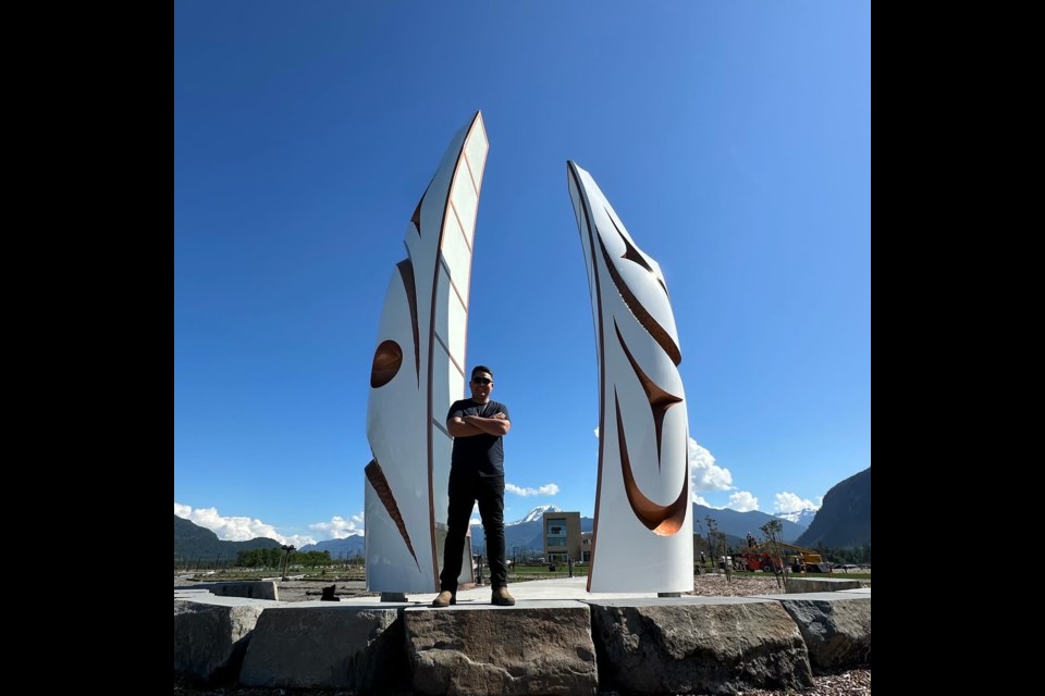 Visual artist James Harry stands before his Welcome Gate, on the Squamish oceanfront.