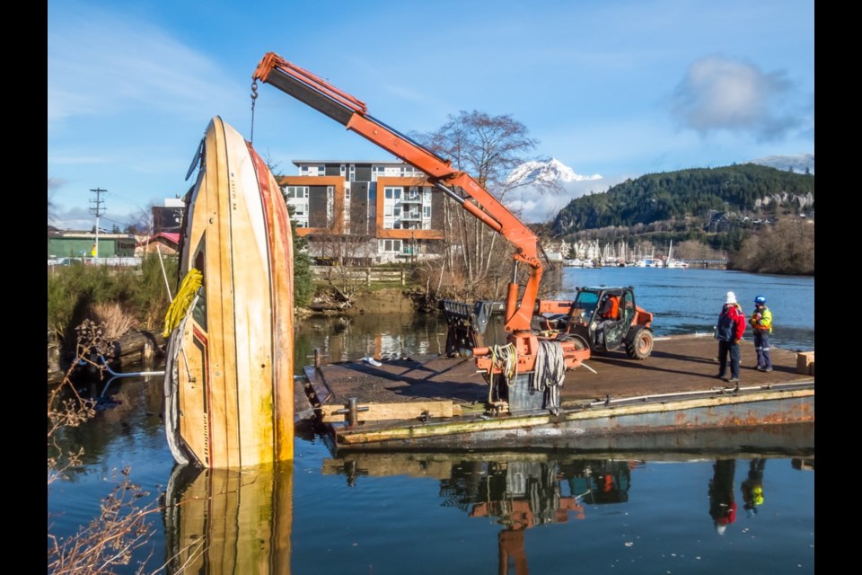 The sunken boat is removed from the Mamquam Blind Channel. 