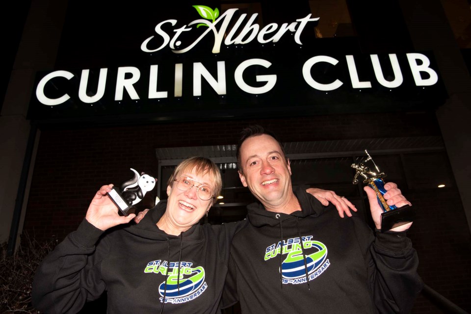 FABULOUS PRIZES — St. Albert Curling Club members Jackie Rae Greening (left) and Jamie Gansauge show off some of the trophies that will be awarded during the club’s 75th anniversary bonspiel this February. Greening is holding the “Skunk” trophy, awarded to the first team to be eliminated from the tournament. KEVIN MA/St. Albert Gazette