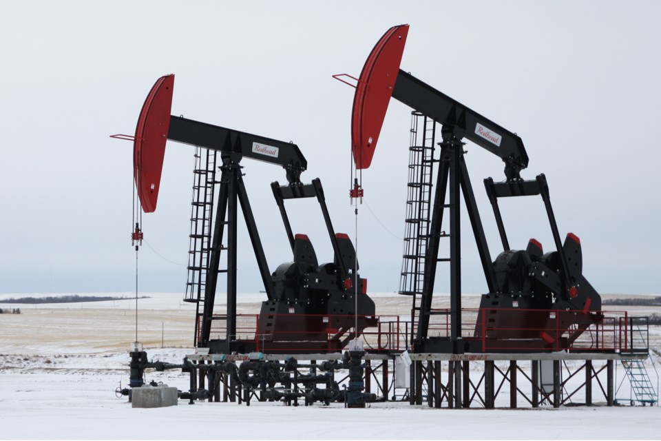 Two pumpjacks frame a picturesque farm in Kneehill County near Three Hills, Alta., on Tuesday, Feb. 4, 2020. CLAIRE THEOBALD/Photo