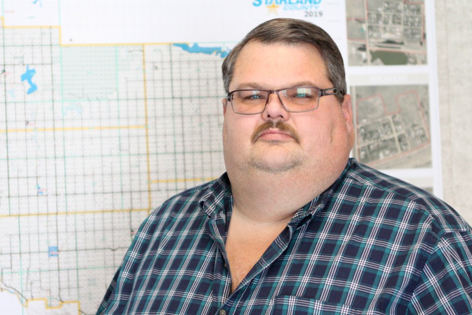 Steven Wannstrom, reeve of Starland County, stands beside a county map on Tuesday, Feb. 4, 2020. With millions in unpaid property taxes owed by oil and gas companies, most insolvent and unable to pay, Wannstrom said his county council had little choice but to increase taxes and fees on residents while making deep cuts to balance their budget. CLAIRE THEOBALD/Photo