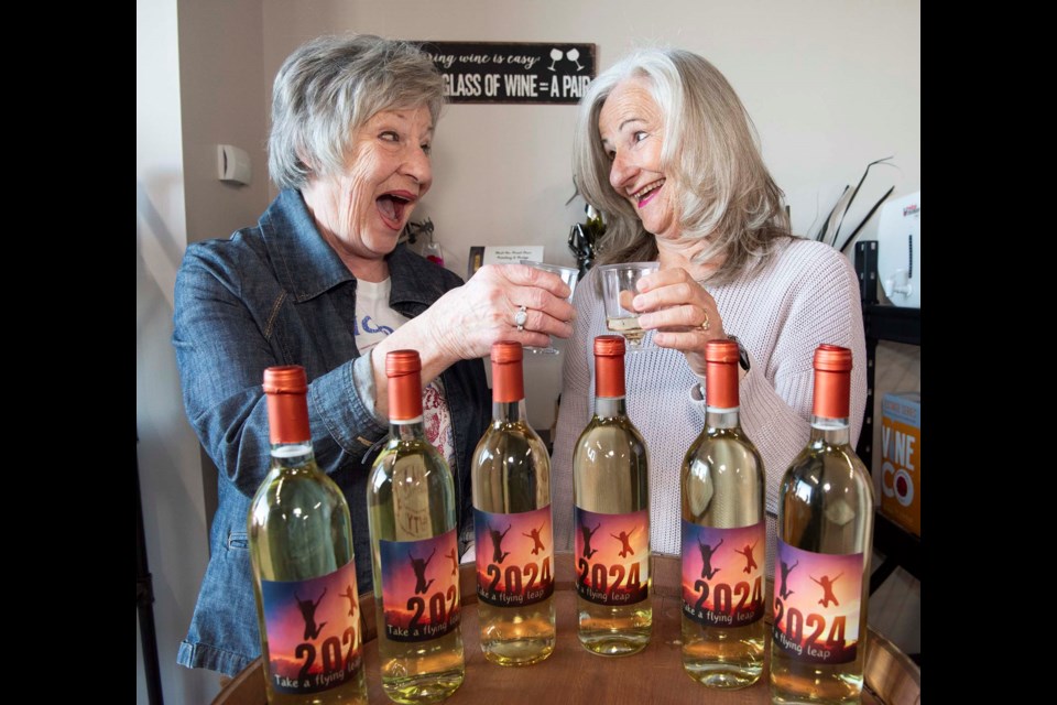 LEGAL DRINKING AGE — St. Albert leap-year babies Muriel Grimble and Marilyn Carlyle-Helms bottled some “Take a Flying Leap” wine earlier this month in preparation for their birthdays on Feb. 29. The pair prepped the wine to celebrate Grimble turning “18” in leap-years. KEVIN MA/St. Albert Gazette