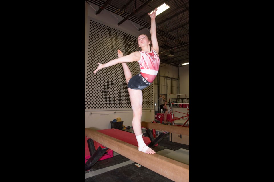 TEAM CANADA — St. Albert gymnast Aila McKinley, 13, demonstrates a stance atop a balance beam at YEG Gymnastics in Edmonton on March 1, 2024. McKinley is competing for Team Canada in Montreal this March 9-10 in the 2024 International Gymnix Junior International Cup. KEVIN MA/St. Albert Gazette