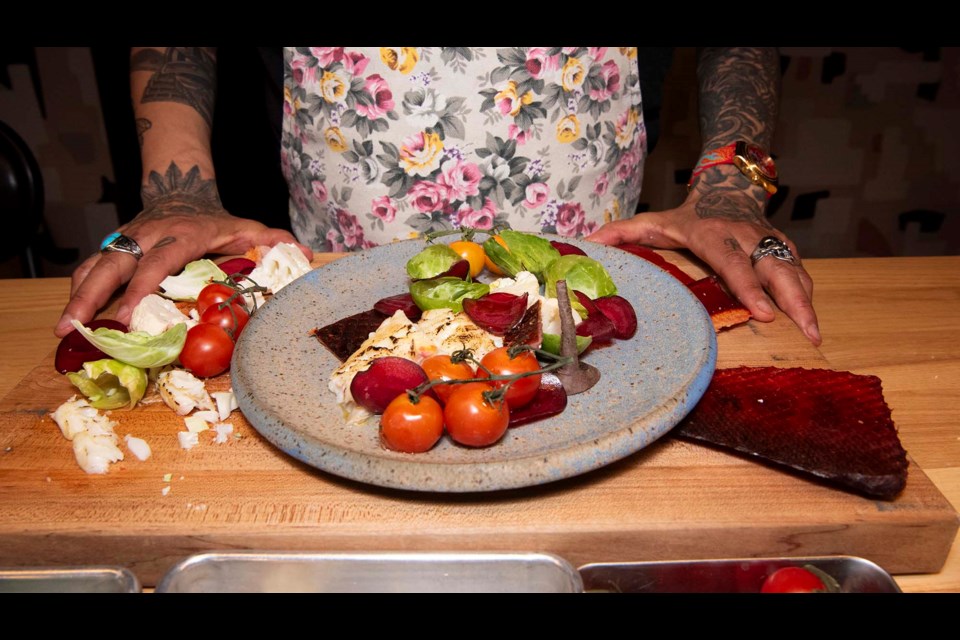 FOOD FROM THE LAND — First Nations Chef Shane Chartrand whipped up this dish to showcase ingredients commonly used in Indigenous cuisine. Shown here are smoked and baked fish, root vegetables, and tubers. Chartrand says his many tattoos reflect his Indigenous heritage and love for cooking. KEVIN MA/St. Albert Gazette