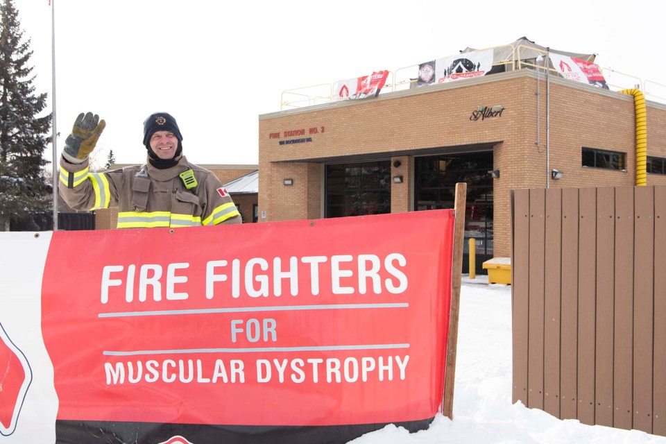 UP TOP — St. Albert firefighter Eric Munn waves to traffic during the 2024 rooftop campaign fundraiser for muscular dystrophy on Feb. 28, 2024. St. Albert firefighters ultimately raised close to $51,000, which was the most raised by any Canadian fire department in this year’s Fill the Boot campaign. KEVIN MA/St. Albert Gazette