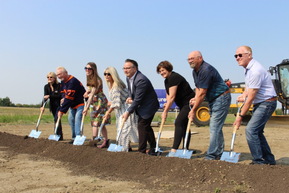 From left to right, Shelley Biermanski, Wes Brodhead, Natalie Joly, St. Albert Mayor Cathy Heron, Minister Dale Nally, Sheena Hughes, Ken MacKay, and Mike Killick place their ceremonial shovels in the ground at the site of Lakeview Business District.