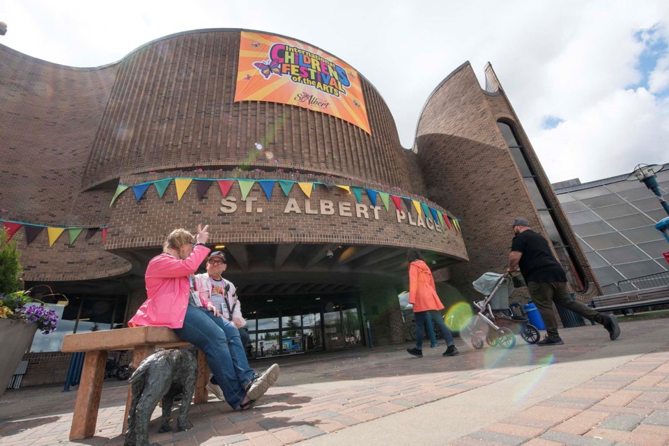 HEART OF ST. ALBERT — City of St. Albert employees Elizabeth Wilkie (in pink) and Ben Sures take a break in front of St. Albert Place on May 31, 2024, during the International Children’s Festival. St. Albert Place celebrated its 40th anniversary on June 2, 2024. KEVIN MA/St. Albert Gazette