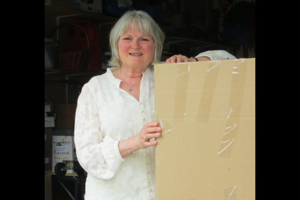 Linda Tutt, St. Vincent de Paul's St. Albert coordinator, stands in her garage packing boxes of goods to be sent to northern communities as part of the North of 60 Project.                          