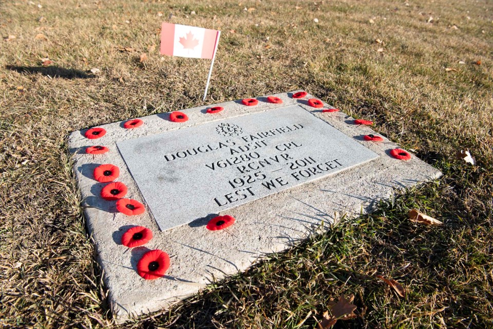 FIELD OF HONOUR — W.D. Cuts placed poppies on military graves in the St. Albert Municipal Cemetery Nov. 4, 2021, as part of the No Stone Left Alone initiative. KEVIN MA/St. Albert Gazette