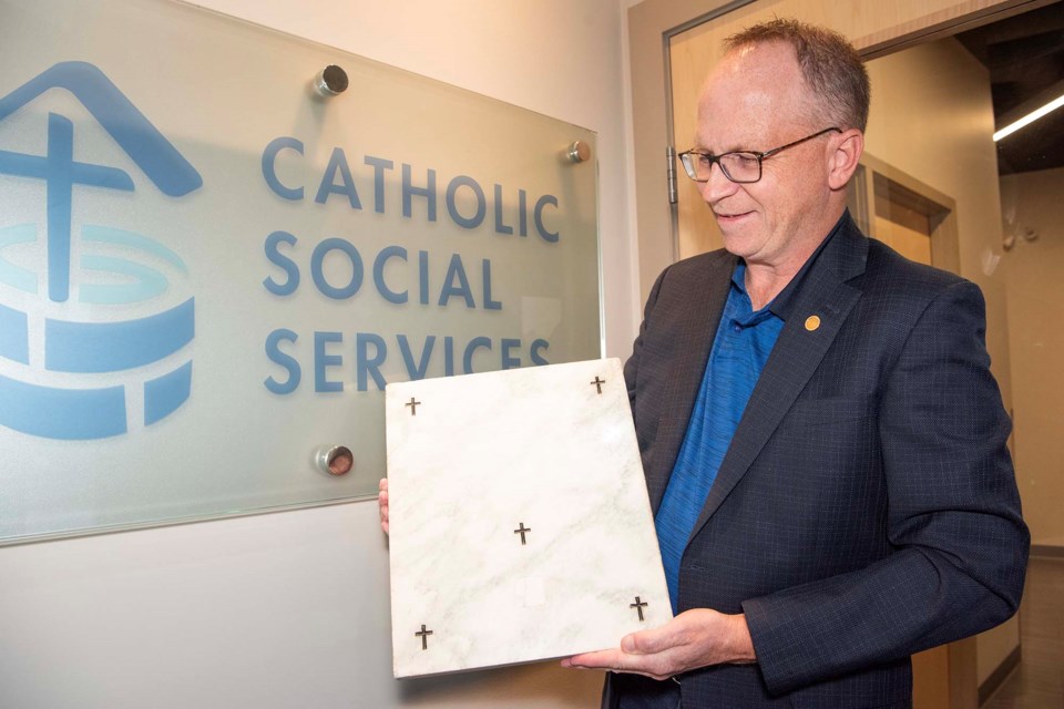 RELIC RECEIVED — Catholic Social Services CEO Troy Davies holds a marble altar stone donated in June 2025 to the organization's Gianna Centre by Greater St. Albert Catholic Schools. The stone contains a relic of St. Gerard Majella, the patron saint of expectant mothers. KEVIN MA/St. Albert Gazette