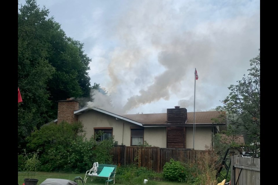 Smoke rises from a residential fire on Larson Avenue and Larose Drive.