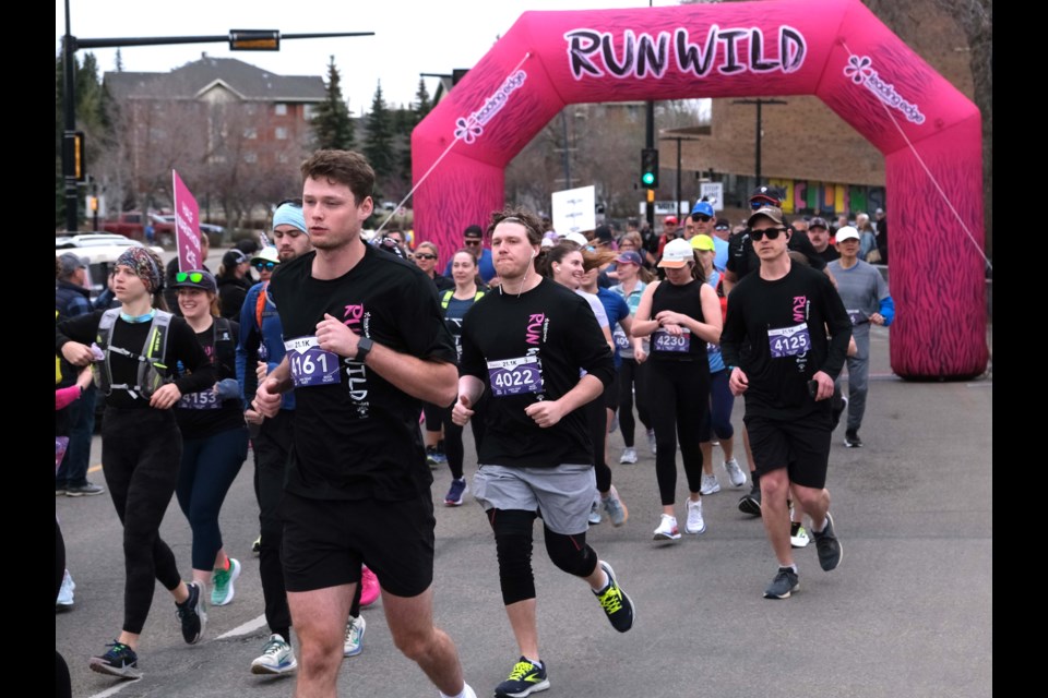 Half Marathon runners at St. Albert's RunWild charity marathon take off outside St. Albert Place.