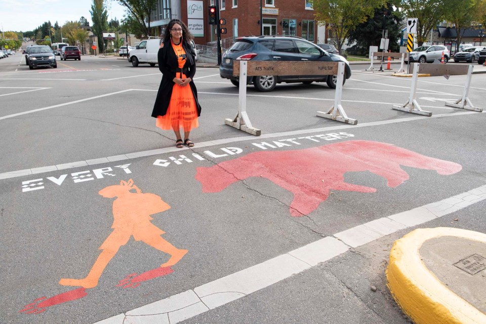 ARTIST — Edmonton artist Karlliea Wood, shown here, designed St. Albert's Every Child Matters crosswalk. The work depicts Indigenous children following the footsteps of a bear whilst accompanied by a bear, which represents courage and healing. KEVIN MA/St. Albert Gazette