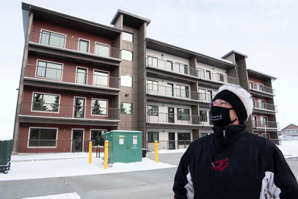 HOME GREEN HOME — Roxanne Brookes, 62, examines the exterior of Paul Krauskopf Court on Feb. 6, 2021. Brookes was one of about 30 people that moved into this just-opened net-zero affordable housing complex last week. KEVIN MA/St. Albert Gazette