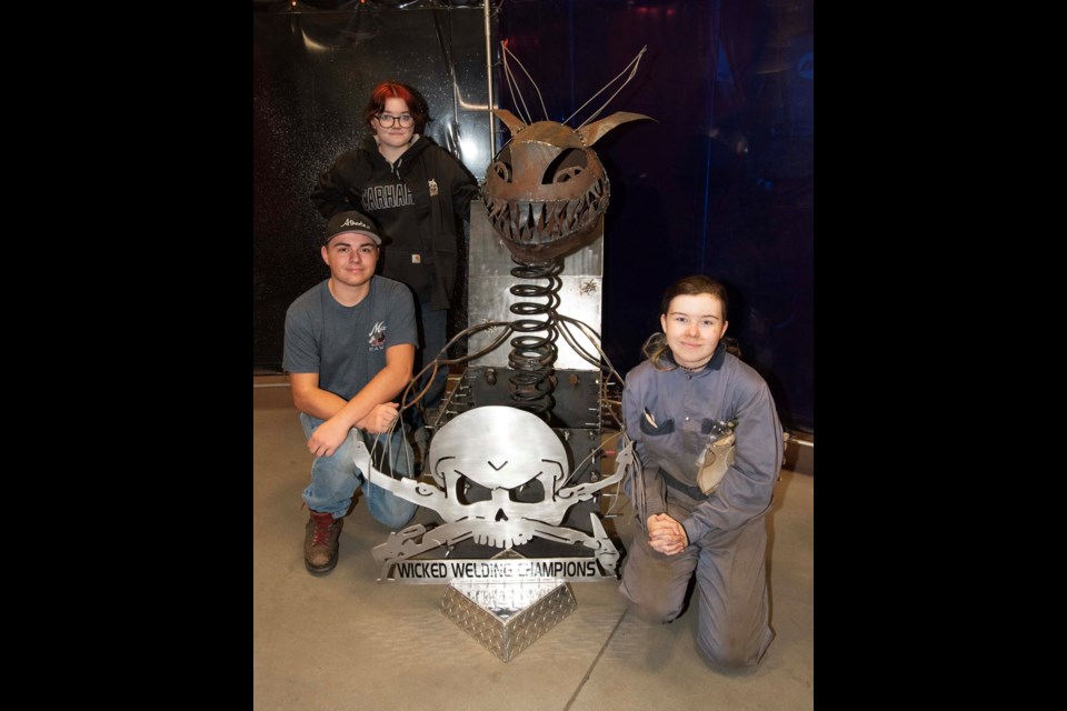 WICKED SKILLS — Sturgeon Composite students Abigail Kondrat (back), Rylan Quilichini (left), and Ashley Verge (front) took first place in the 2023 Wicked Welding competition held Oct. 28 at the CLAC Welding Training Centre in Edmonton. Their winning "Jack-O-Stein" sculpture earned their school $1,000. KEVIN MA/St. Albert Gazette