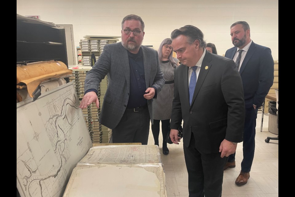 Minister Dale Nally checks out a land title from 1887 at a press tour of the land titles office in Edmonton. RILEY TJOSVOLD/St. Albert Gazette