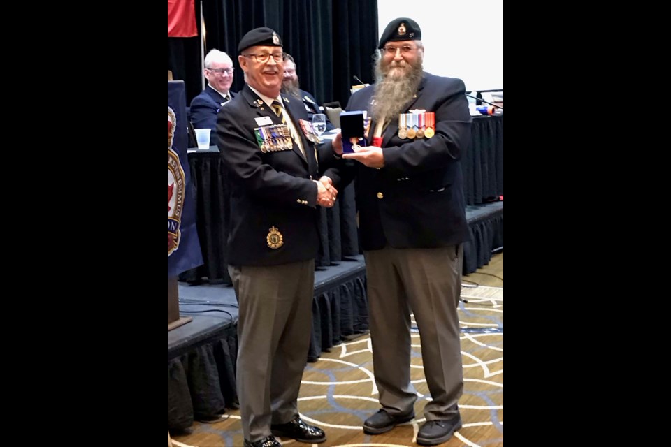 MEDALLED — Morinville Legion member Bob Peterson (right) received the Sovereign's Medal for Volunteers from John Mahon of the Royal Canadian Legion May 8, 2022, during a Legion convention in Red Deer. Peterson was recognized for his many years of volunteer work with the Legion. ANN HABERER/Photo