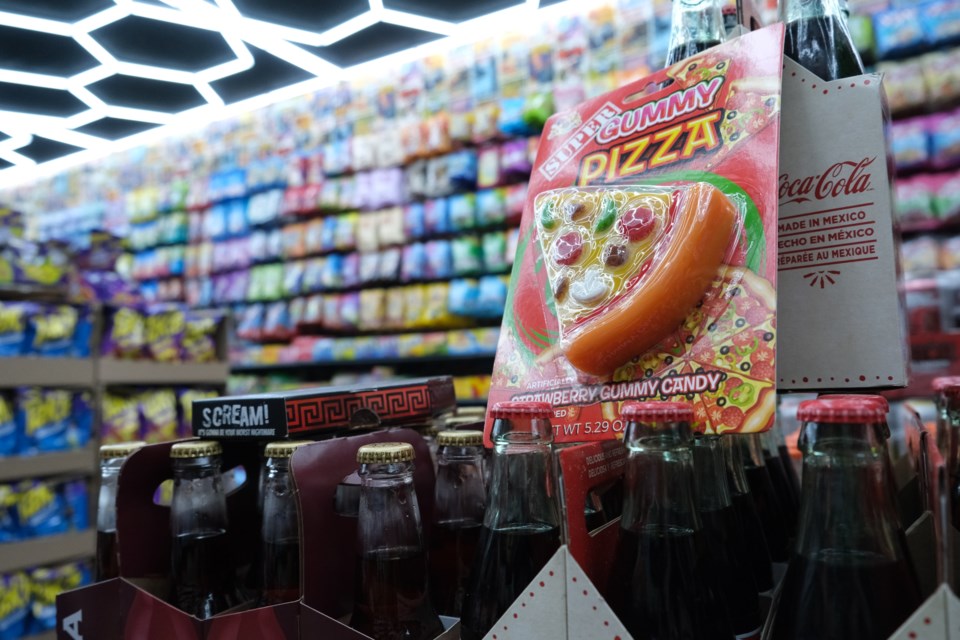 A strawberry-flavoured gummy pizza rests atop a box of Mexican Coca-Cola at St. Albert's newest candy store, Dynamite Candy, set to open May 17. RILEY TJOSVOLD/St. Albert Gazette