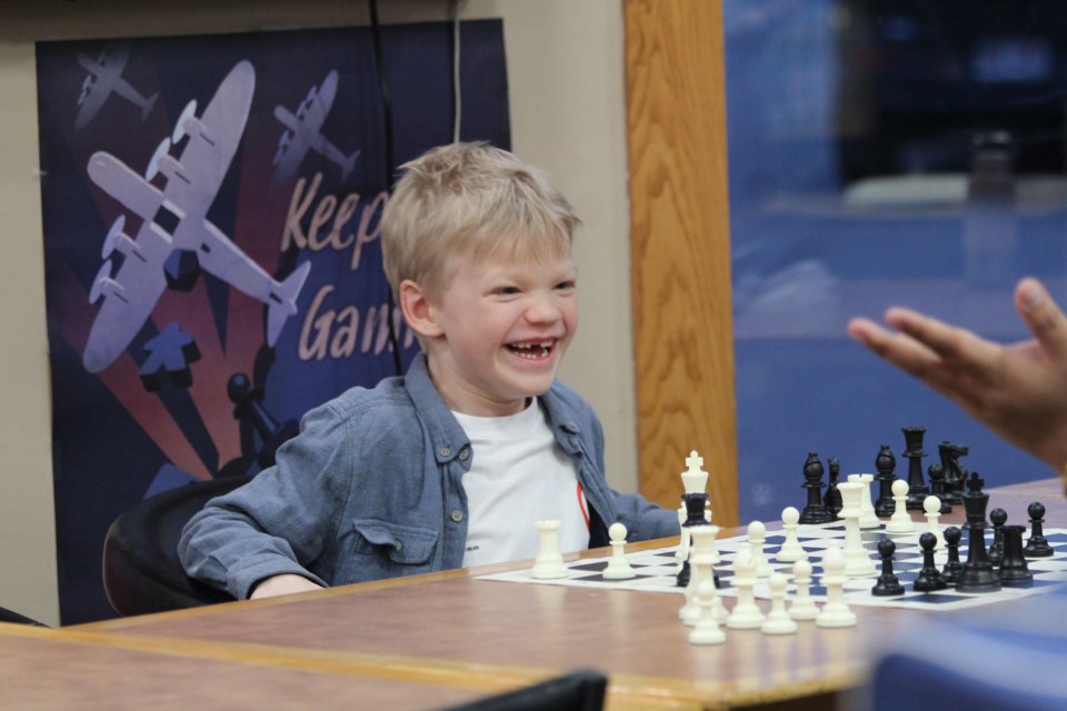 Platon laughing at his opponent's surprise after playing a move during an April 11 match at Mission Fun & Games. JACK FARRELL/St. Albert Gazette