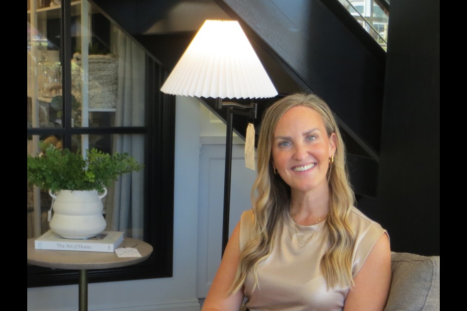 Heather Jespersen, co-owner of Simone & Ivy, notes that pleated lampshades similar to the standing lamp behind her, offer  a timeless elegance.                               