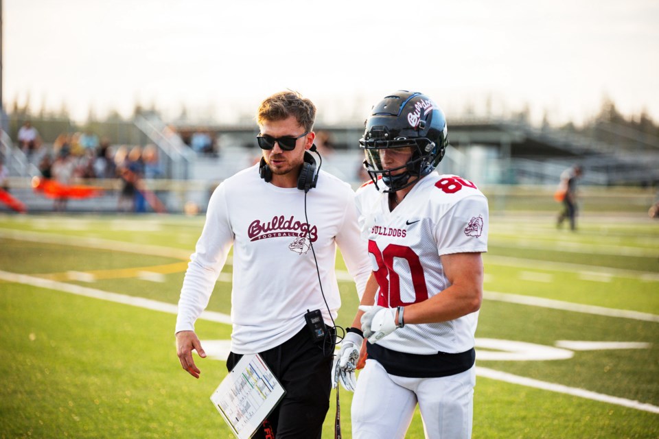 Bellerose head coach Zach Wilkie talking with his receiver Jack MacLeod during a football game last year. 