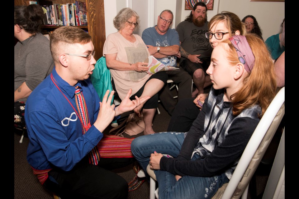 IT'S LIKE THIS – Josh Morin (left) explains to Lac Ste Anne resident Bella Parry how she would introduce herself in Michif. The two were among the 20-odd people who are taking part in a Michif language conversation club running all summer at Michif Cultural Connections. 