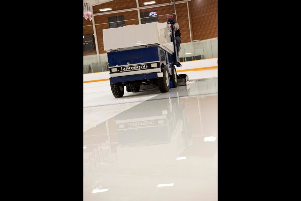 ACTUALLY ICE — City of St. Albert worker Nathaniel Curry drives a Zamboni stocked with water from a REALice water treatment system on Jan. 24, 2021. The system lets him resurface the rink without the use of hot water, reducing energy costs. KEVIN MA/St. Albert Gazette