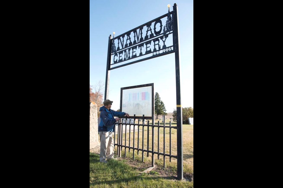 VOLUNTEER RUN – Namao Cemetery volunteer Gordon Carson checks out the cemetery map compiled by the late Jack Speers. Speers had a hand in many of the cemetery's current features, such as this large entrance sign and the columbarium next to it. 
KEVIN MA/St. Albert Gazette
