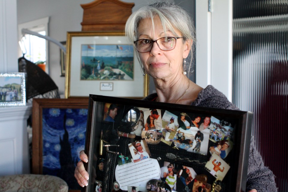 Annie Boychuk clutches a collage she made filled with memories of her late husband on Friday, March 6, 2020. Brent Boychuk died of a heart attack outside of a closed Sylvan Lake clinic in 2012. CLAIRE THEOBALD/Local Journalism Initiative