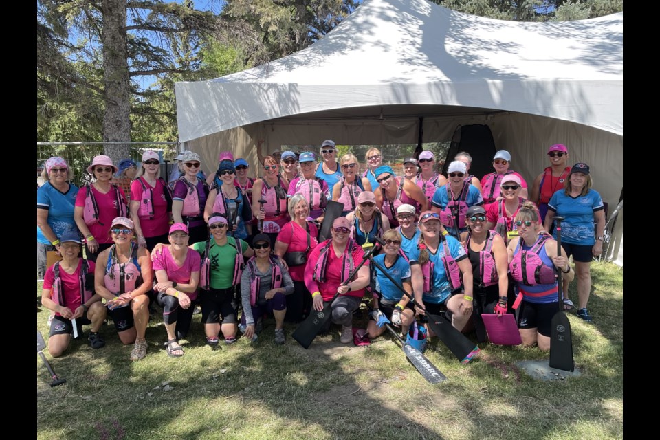 Members of the Breast Friends dragon boat team pose together for a cheer before hitting the water. BREAST FRIENDS/Supplied
