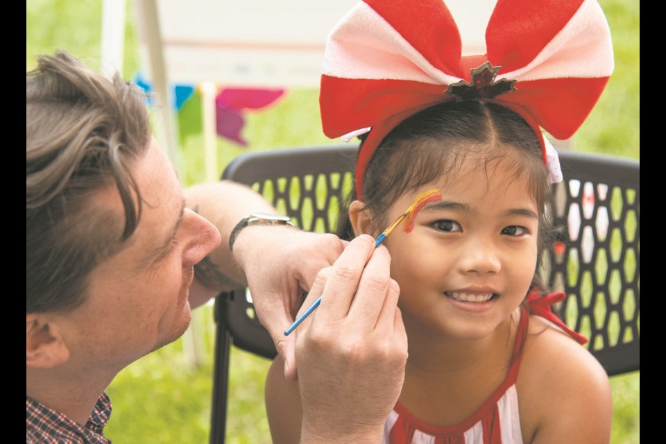 Mira Rosario, 6, gets her face painted at the Canada Day celebrations at Servus Place in St. Albert. 